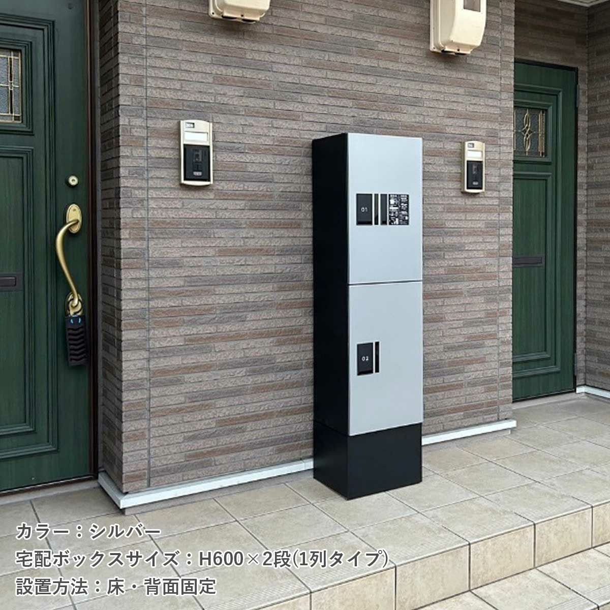 アパートの前に宅配ボックスが設置されている。宅配ボックスのカラーはシルバー。宅配ボックスのサイズH600×2段（1列タイプ）。設置方法は床・背面固定タイプ。